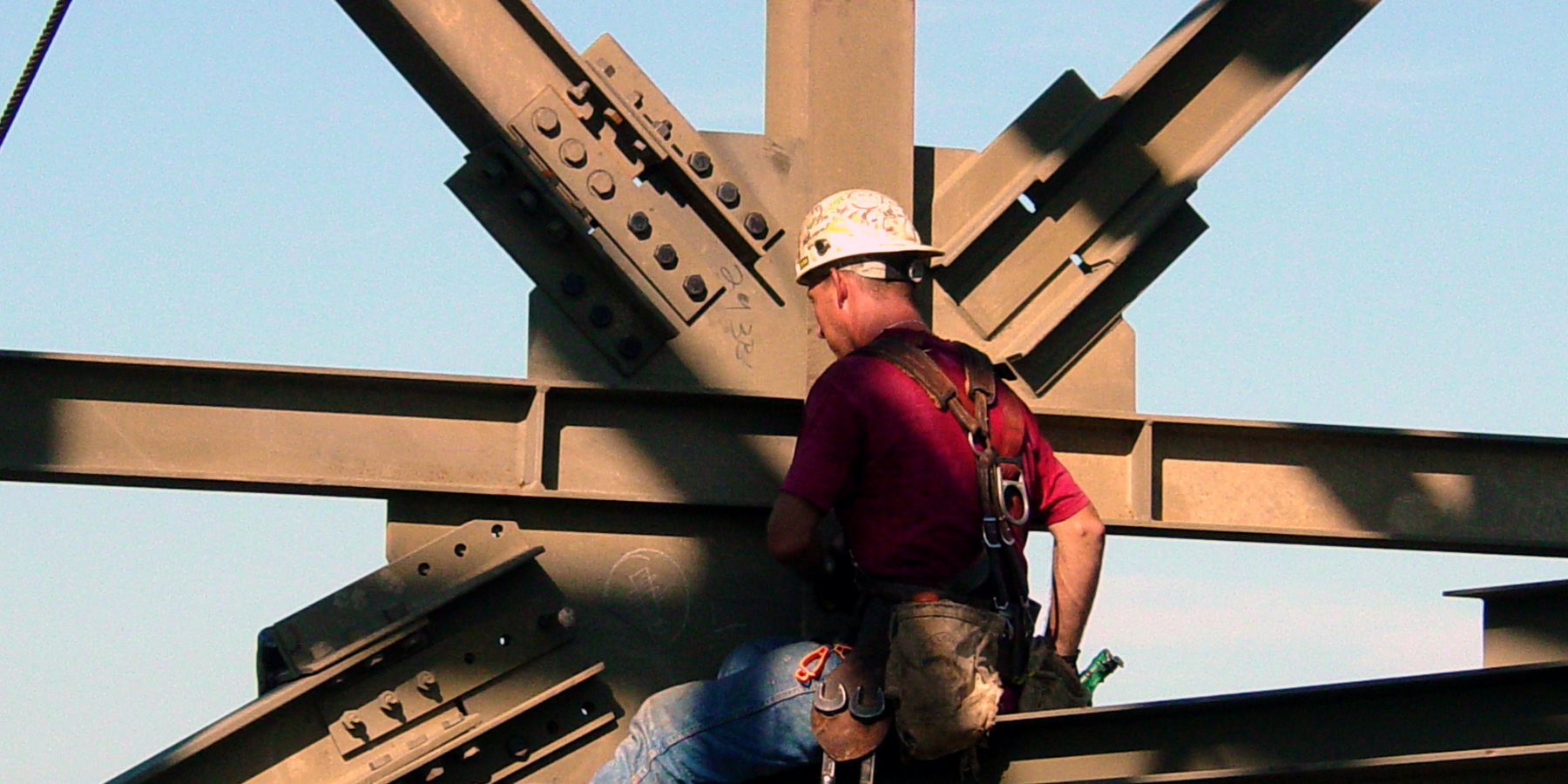 Worker in hard hat working on a structural beam